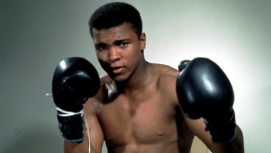 Muhammad Ali poses with his boxing gloves. Action Images/Sporting Pictures
