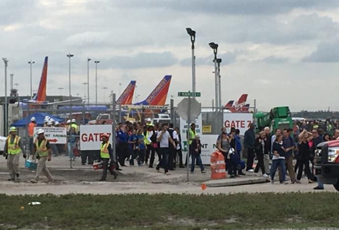 Travelers and airport workers are evacuated out of the terminal after airport shooting at Fort Lauderdale-Hollywood International Airport in Florida, U.S., January 6, 2017. REUTERS/Andrew Innerarity