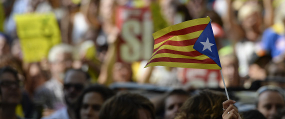 A woman holds a Catalan pro-independence 'estelada' flag outside the high court in Barcelona on September 21, 2017. After a day-long protest that lasted well into the night, several thousand independence supporters gathered again in front of the high court in what influential separatist organisations said would be a "permanent mobilisation" until the officials are freed. / AFP PHOTO / Josep LAGO (Photo credit should read JOSEP LAGO/AFP/Getty Images)