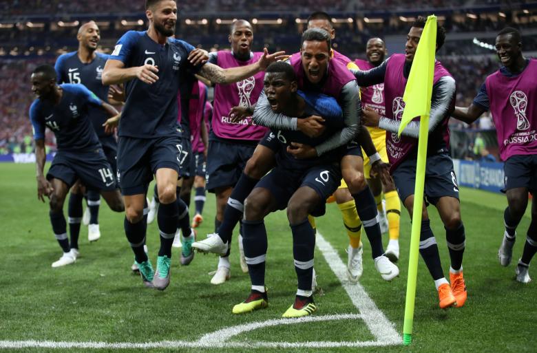 France's Paul Pogba celebrates scoring their third goal with team mates. REUTERS/Carl Recine